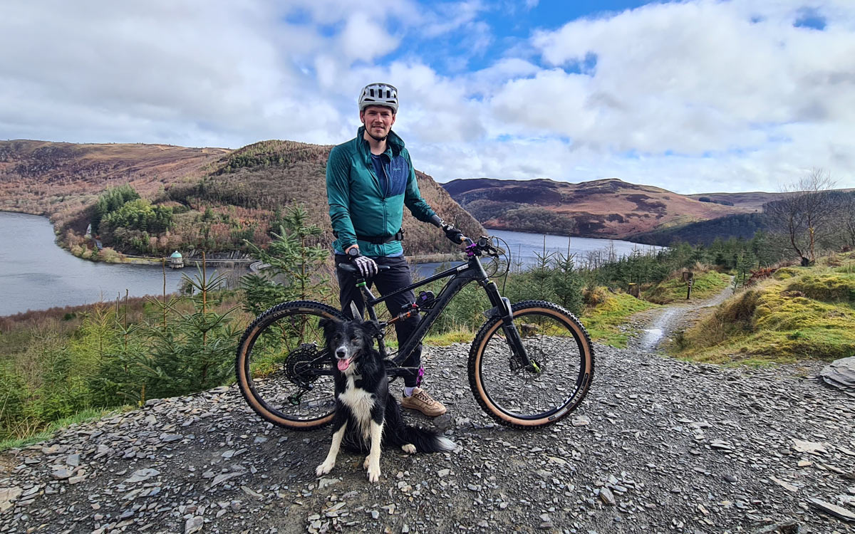 A mountain biker with his mountain bike and dog